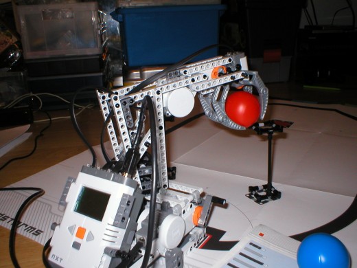 An NXT based robot arm lifting a ball.